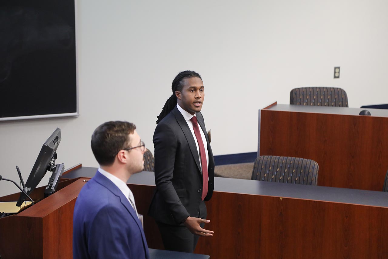 Two students leading a discussion in a student organization meeting
