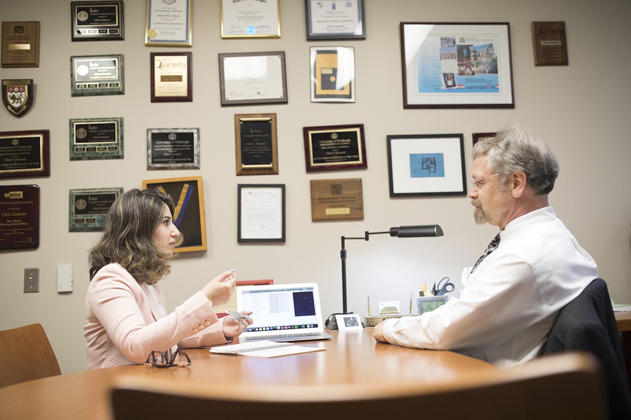 A PhD student discussing their research with a faculty member