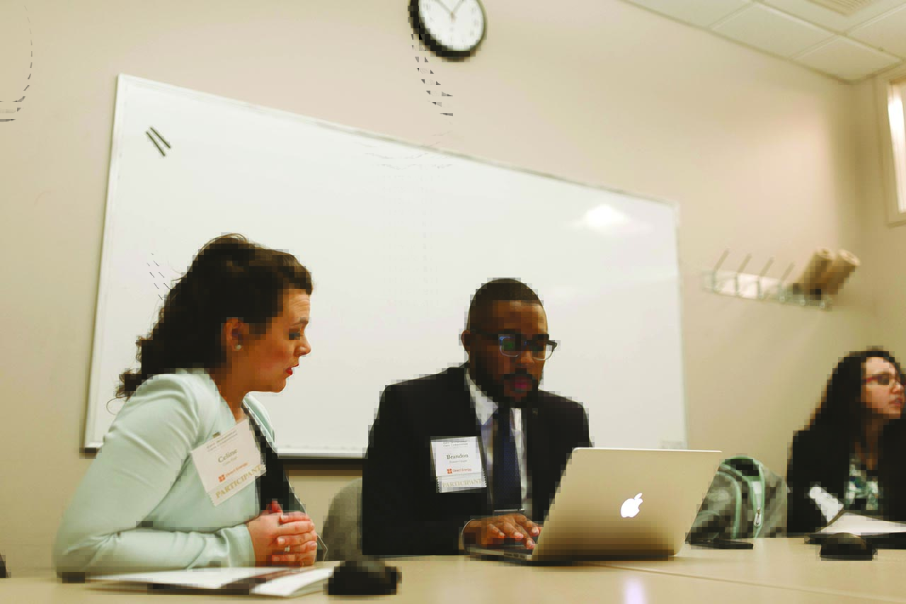 Two corporate recruiters reviewing a website on a laptop Two corporate recruiters reviewing a website on a laptop