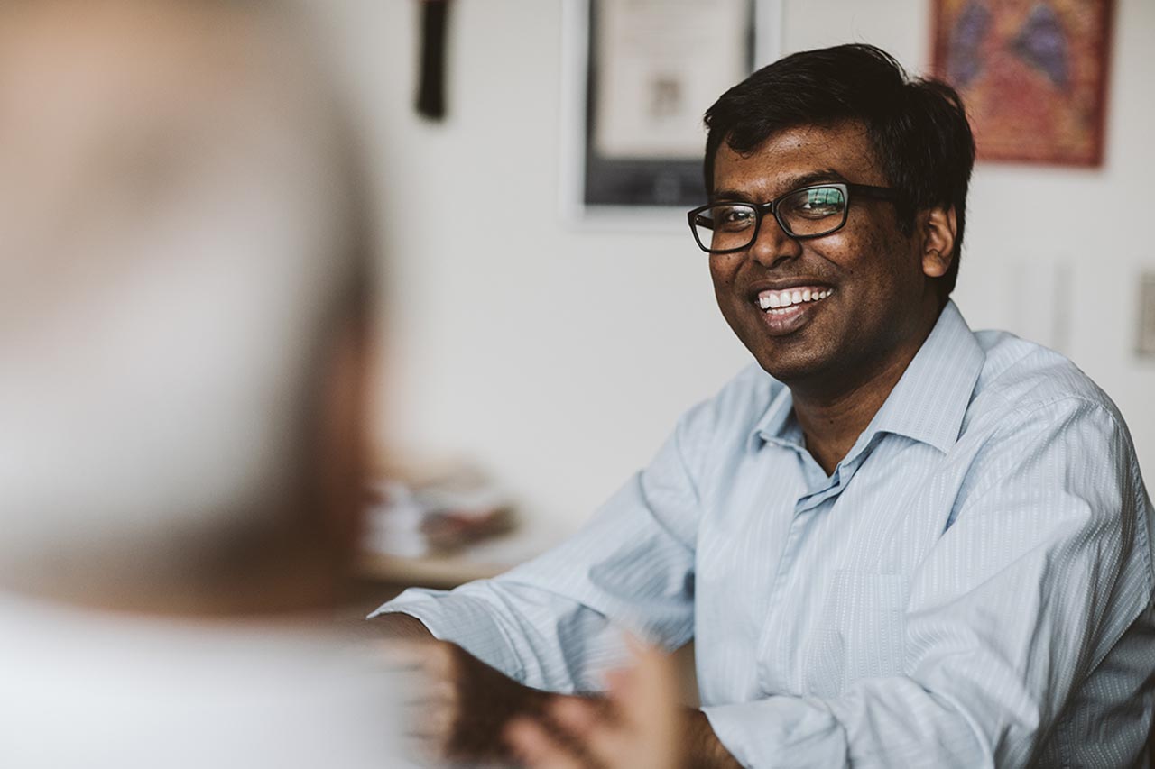 Graduate student smiling while in discussion with advisor