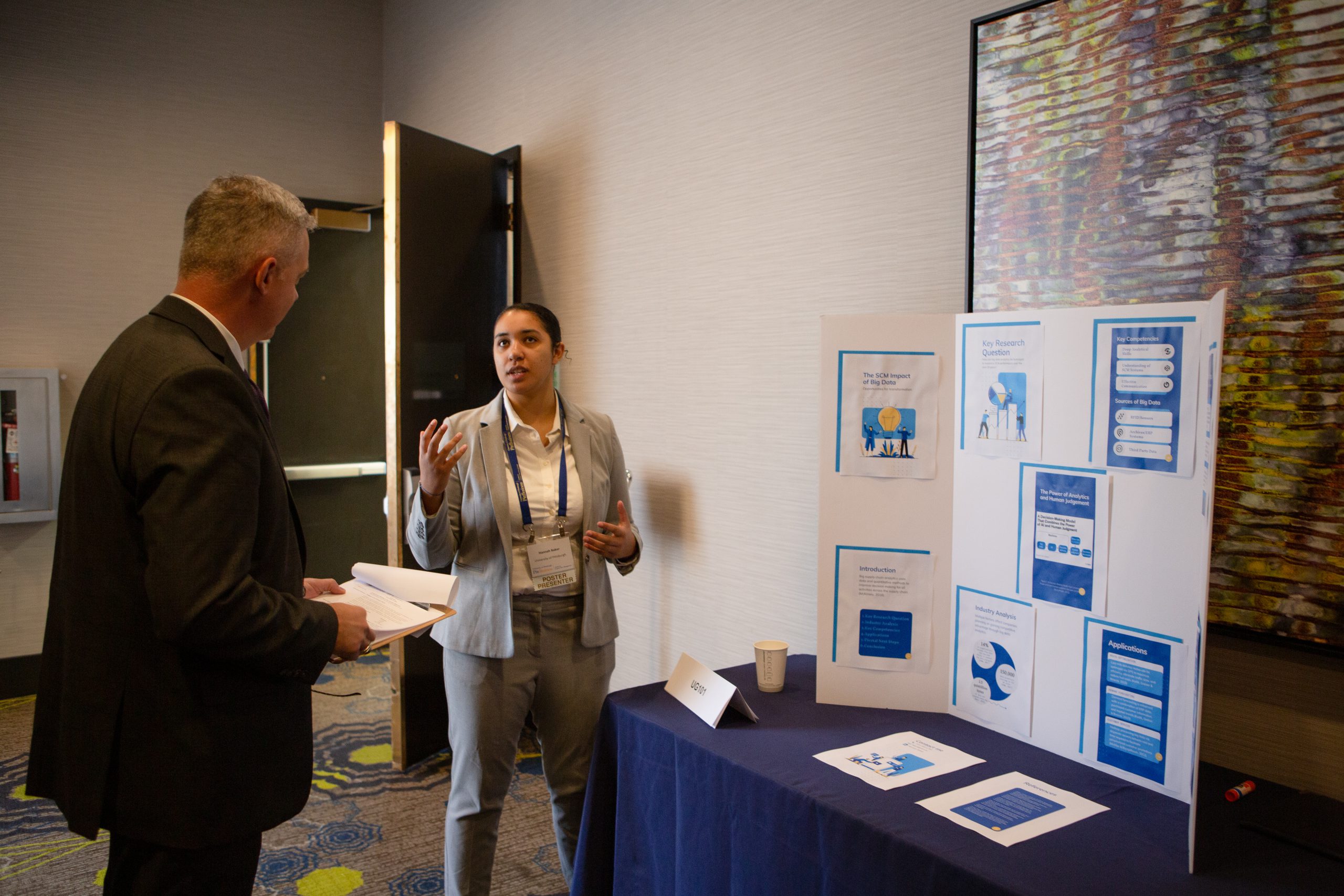 IMG02045 Graduate student smiling while in discussion with advisor
