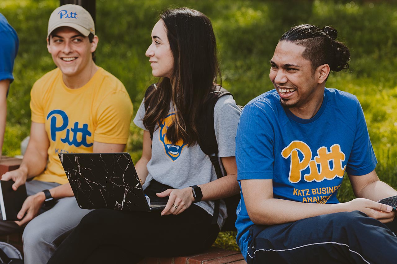 Alumni portrait in dramatic lighting in front of a darkened background