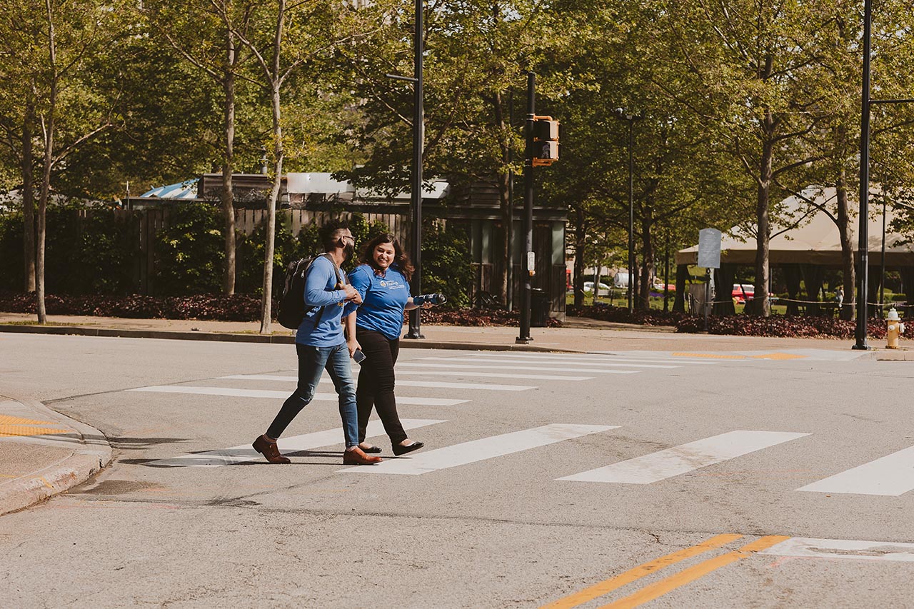 Students walking into Mervis Hall